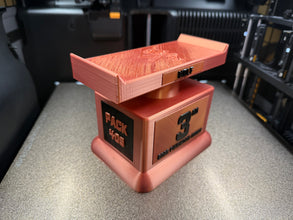 Small trophy with text on a textured surface