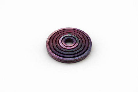 red and black ring shaped sensory toy on a white background