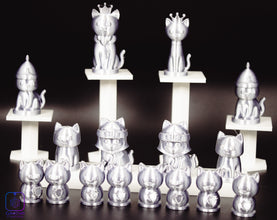 Silver cat figurines with various poses on a dark background